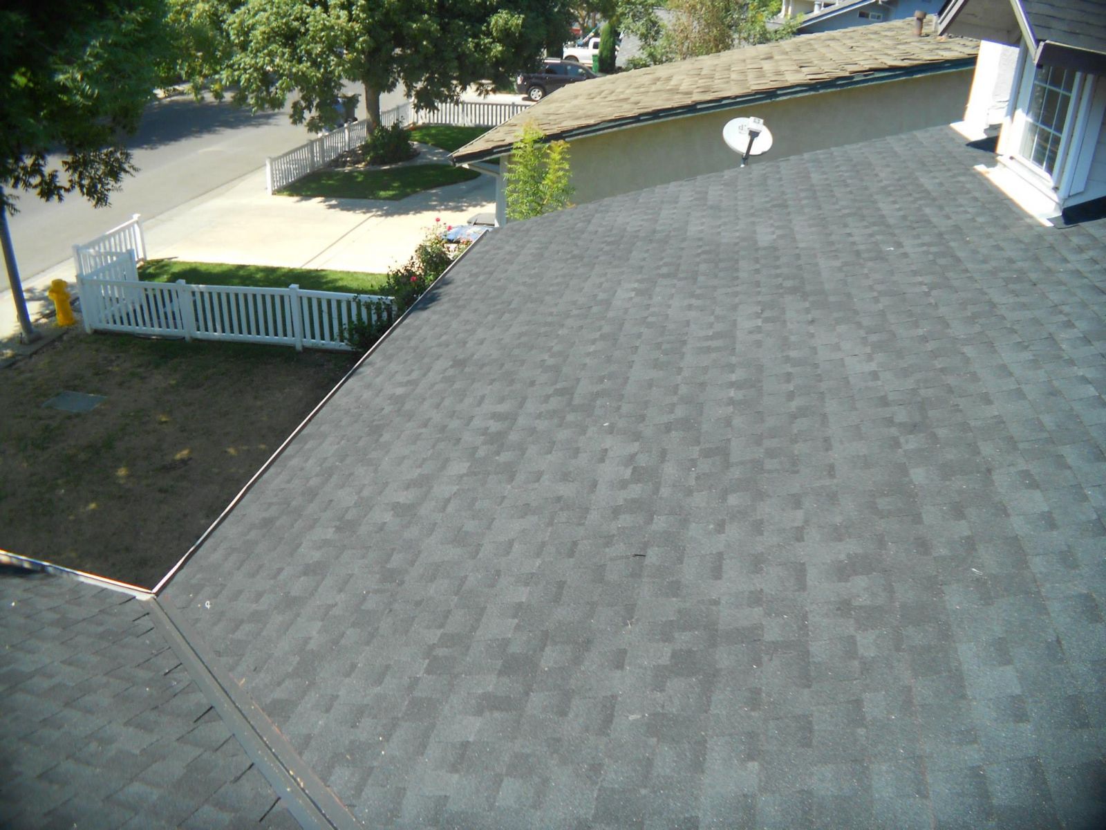 Close up of a residential roof with new gray shingles installed (different angle)
