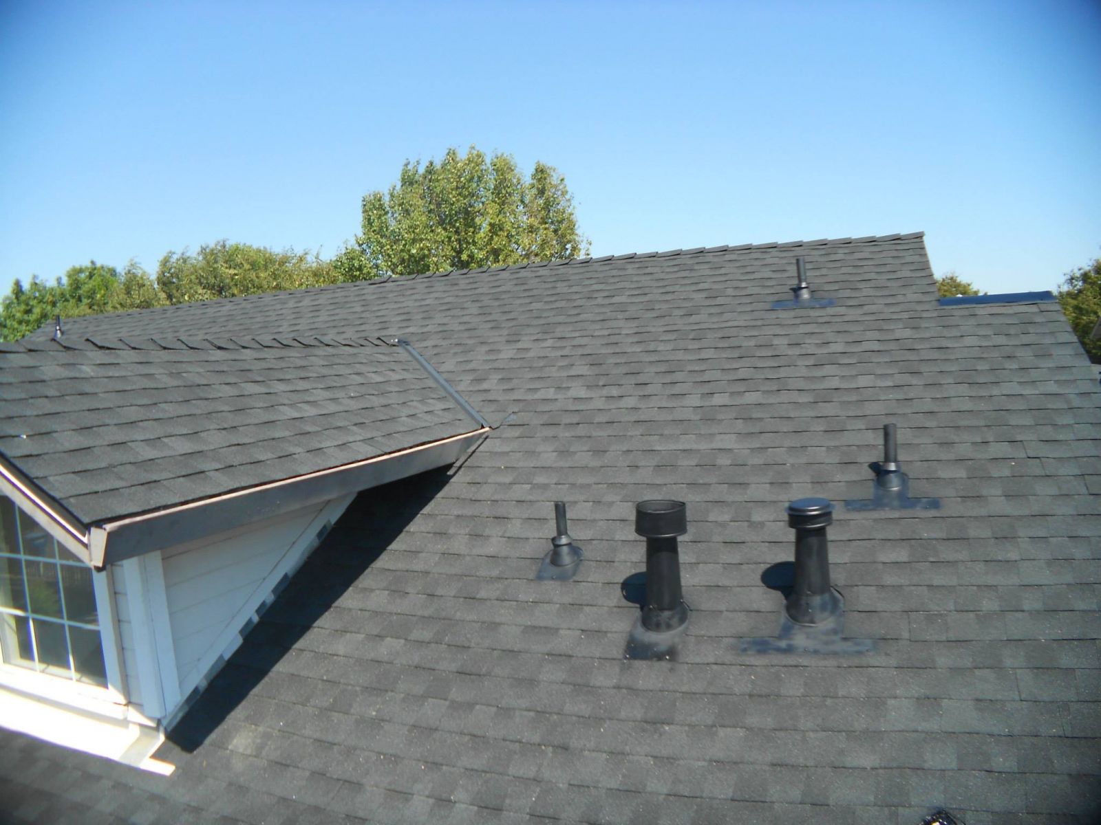 Close up of a residential roof with new gray shingles installed